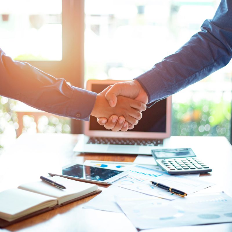 Successful of businessmen shaking hands after discussing good de