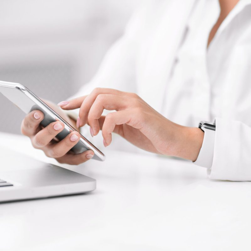 Modern Technologies. Closeup of female hands, latin girl using mobile phone, writing post. Free space, panorama